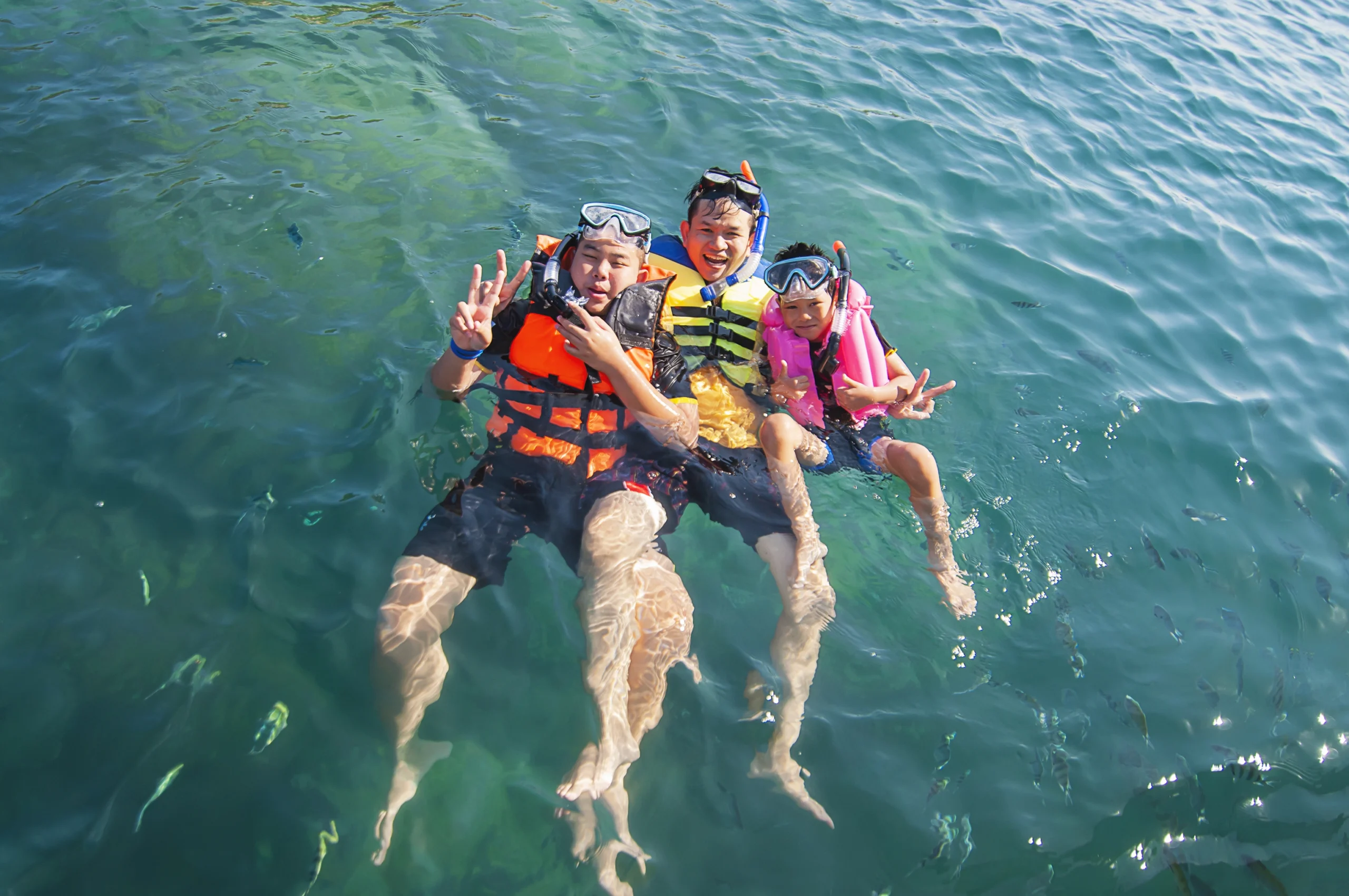 three-guys-floating-happily-sea-water